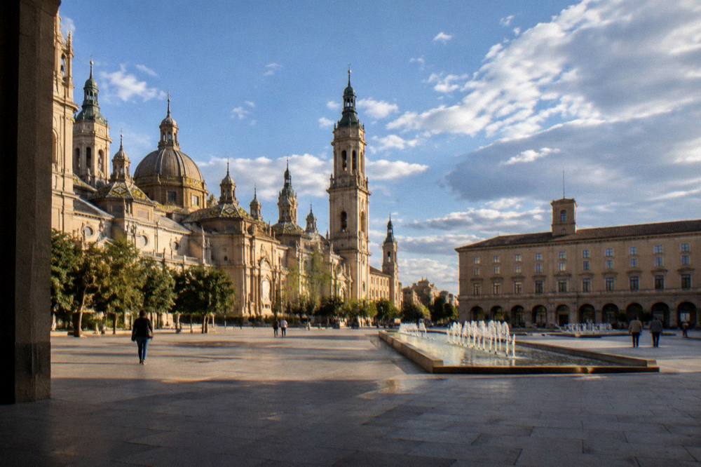 A quiet stone square in Zaragoza old town in warm late afternoon light