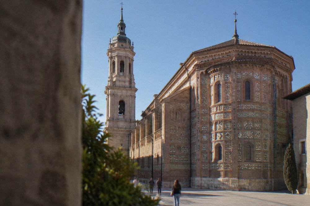 The Mudéjar brick apse of La Seo cathedral lit by afternoon sun