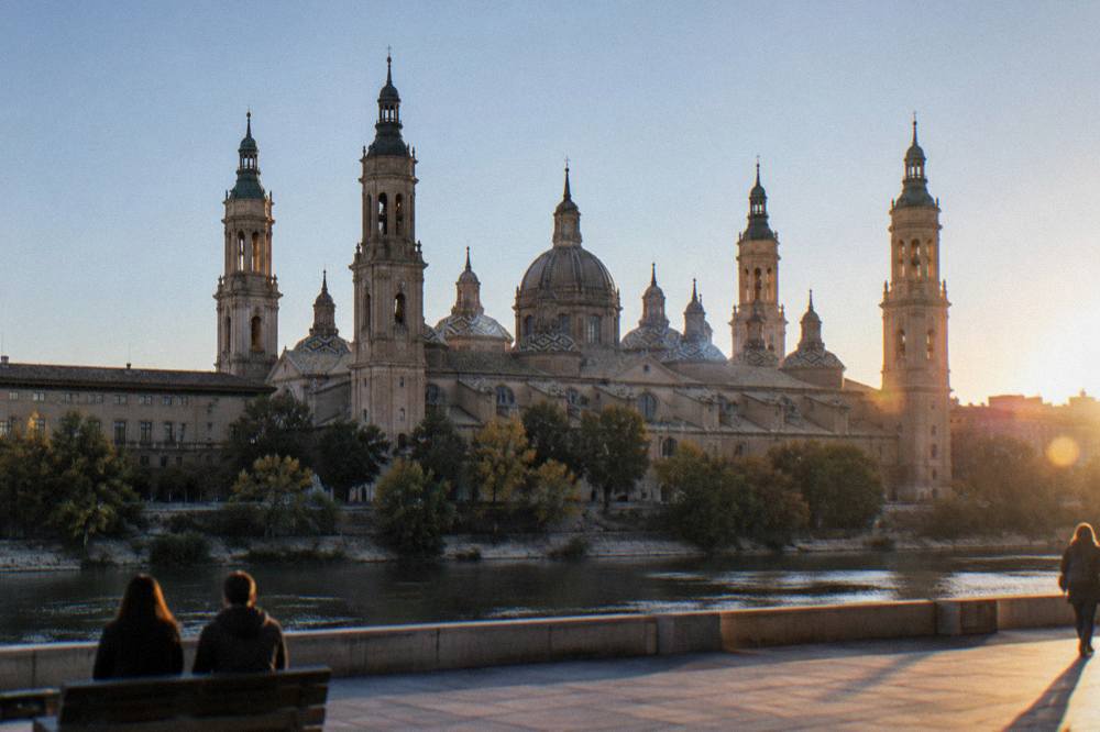 The baroque towers of the Basilica del Pilar seen from across the Ebro at sunset
