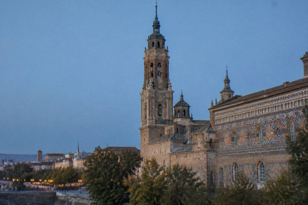 The Mudéjar brick tower of La Seo cathedral rising above the old town rooftops of Zaragoza