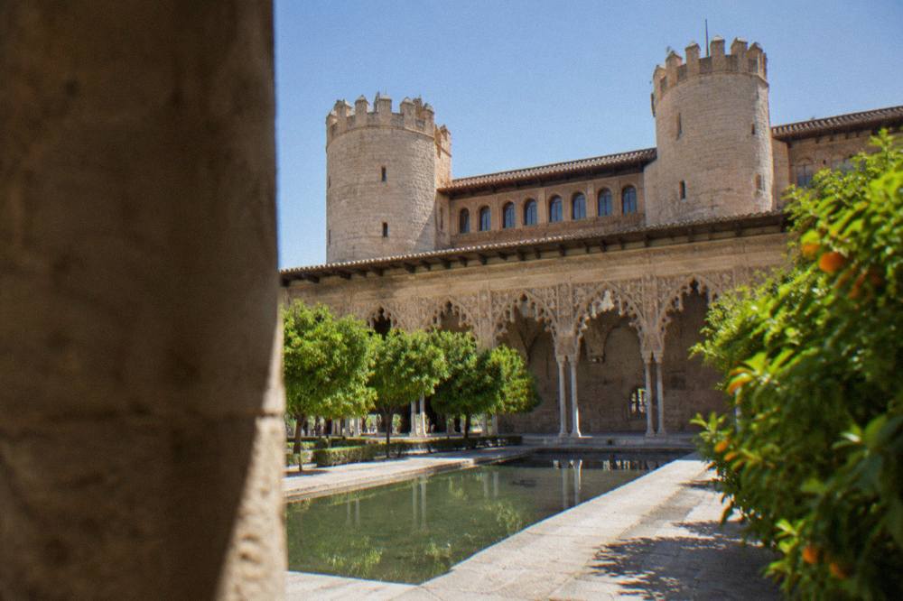 The Aljafería palace courtyard in Zaragoza with its ornate Moorish arches