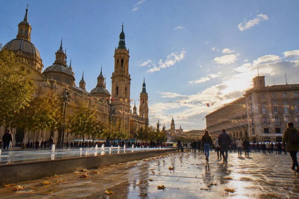 The Plaza del Pilar in Zaragoza with crowds and festival bunting during the October fiestas