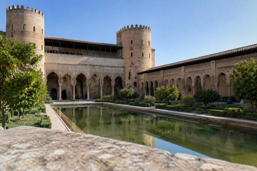 Clear skies over the Aljafería palace gardens in Zaragoza on a sunny afternoon