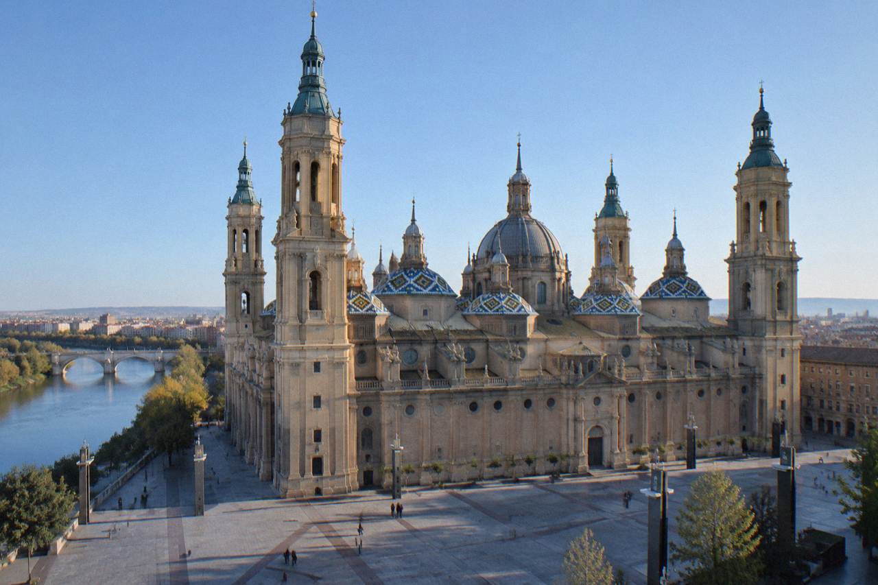 The towers of the Basílica del Pilar seen from across the Ebro river at sunrise