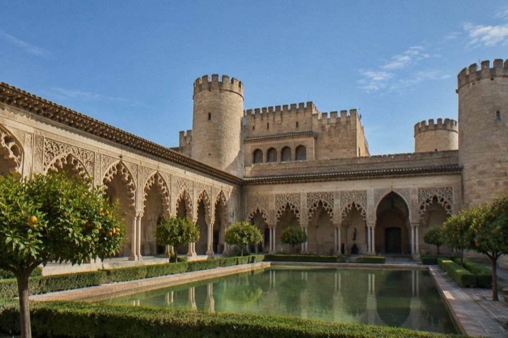 The ornate arches and carved plasterwork courtyard of the Aljafería palace in Zaragoza