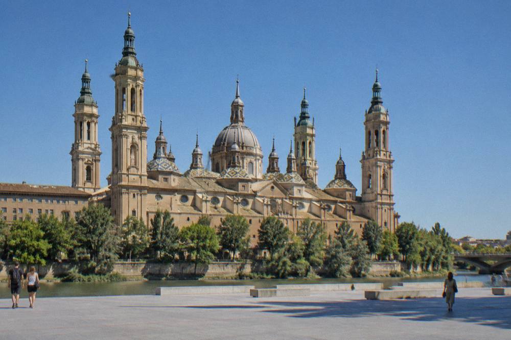 The baroque interior of the Basílica del Pilar with its columns and painted domes
