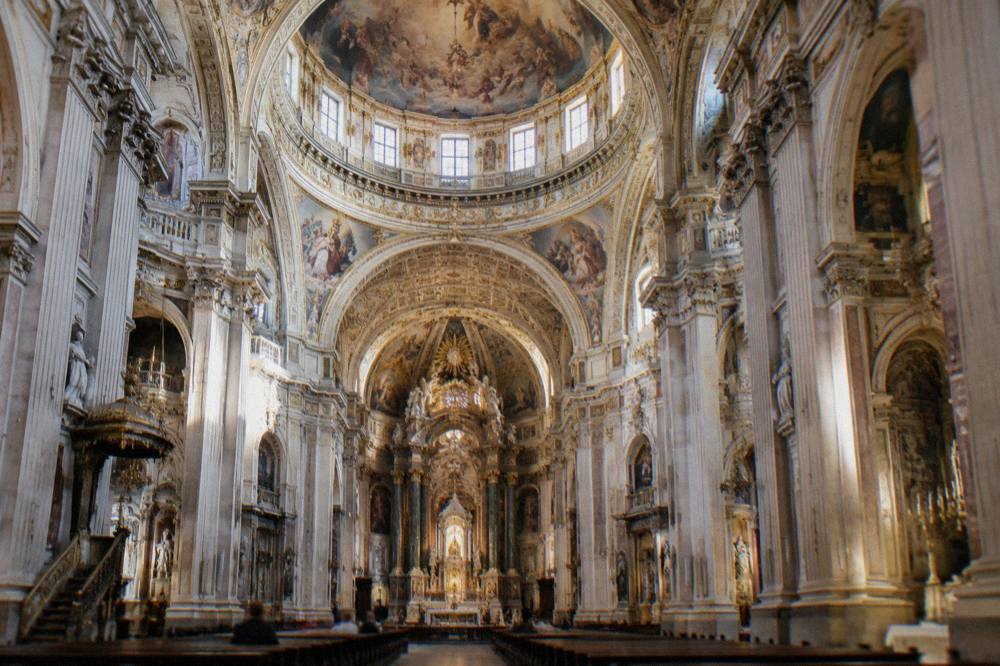 The baroque dome and ceiling frescoes inside the Basilica del Pilar seen from the nave