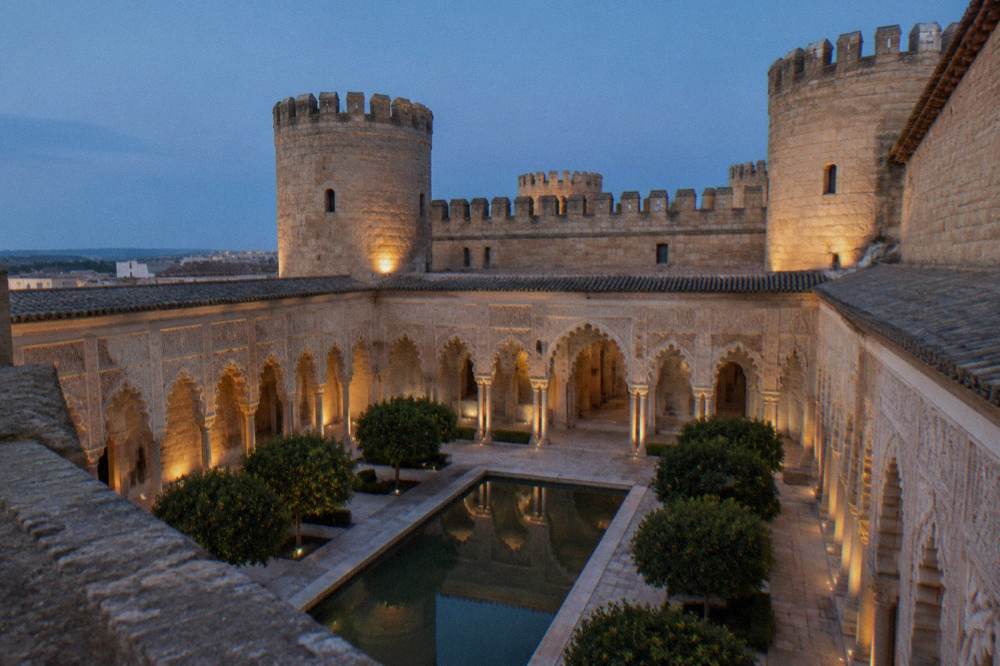 The ornate Moorish arches and carved plasterwork of the Aljaferia palace courtyard