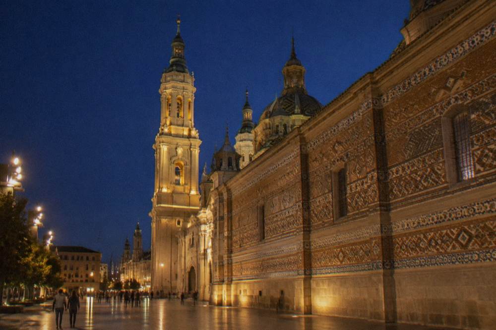 The floodlit facade and towers of La Seo cathedral in Zaragoza at night