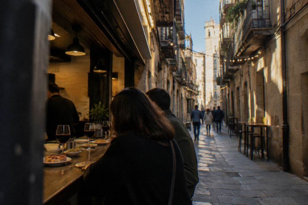 A tapas bar counter in Zaragoza with small plates and glasses of red wine