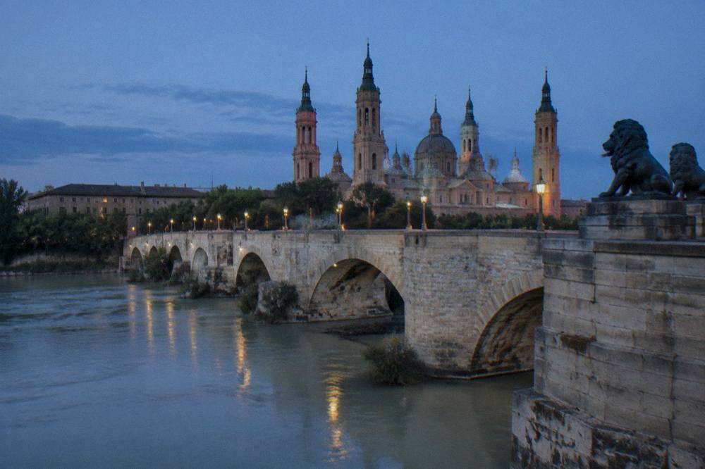 The Puente de Piedra stone bridge over the Ebro river in Zaragoza after rain
