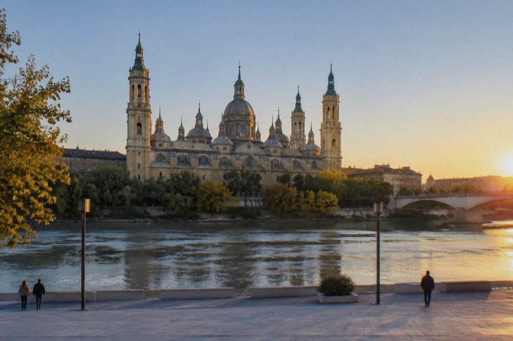 The Ebro river and the Basílica del Pilar skyline seen from the far bank at sunset