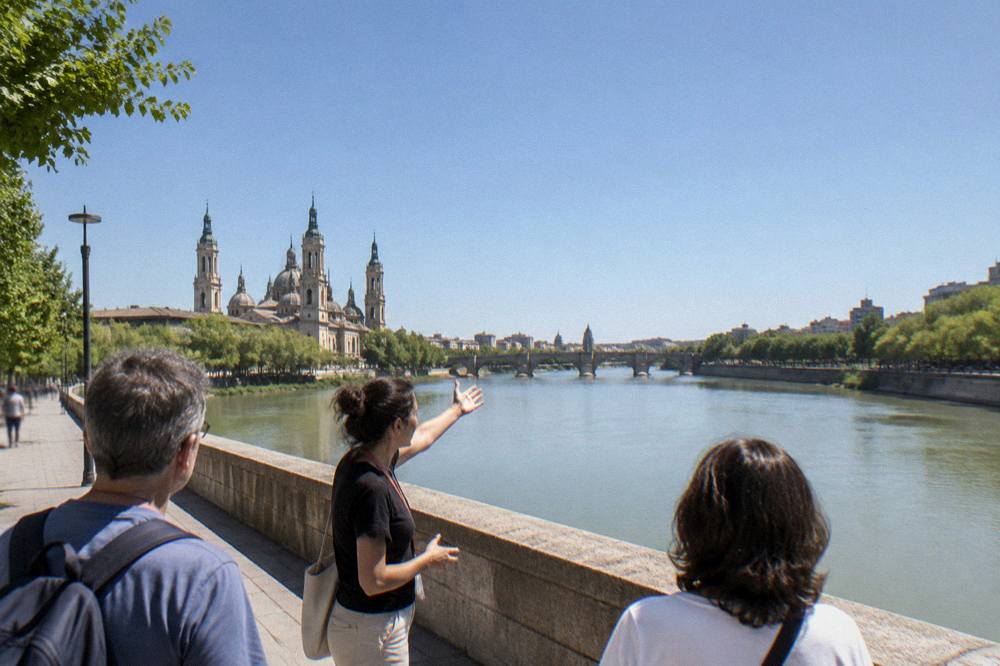 A local guide showing a couple old-town street details on a walking tour